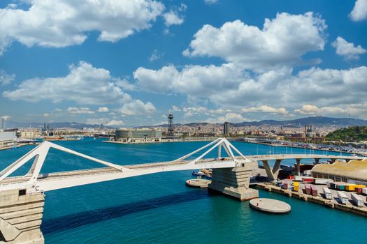 White bridge across blue water of Barcelona Harbor