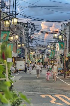 Retro old-fashionned shopping street Yanaka Ginza famous as a spectacular spot for sunset golden hour from the Yuyakedandan stairs which means Dusk Steps at Nishi-Nippori in Tokyo. Yanaka Ginza is also named the Evening Village.