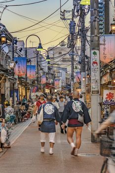 Retro old-fashionned shopping street Yanaka Ginza famous as a spectacular spot for sunset golden hour from the Yuyakedandan stairs which means Dusk Steps at Nishi-Nippori in Tokyo. Yanaka Ginza is also named the Evening Village.
