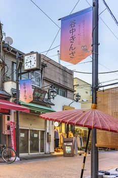 Retro old-fashionned shopping street Yanaka Ginza famous as a spectacular spot for sunset golden hour from the Yuyakedandan stairs which means Dusk Steps at Nishi-Nippori in Tokyo. Yanaka Ginza is also named the Evening Village.