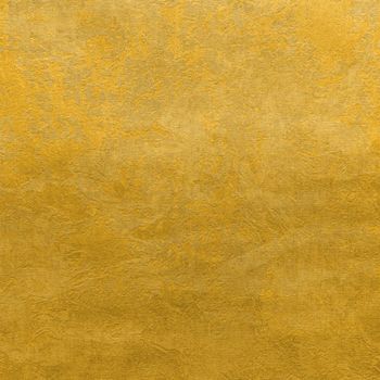 Abstract grungy decorative texture. Textured paper with copy space. The mottled surface of mustard yellow paper, texture closeup.