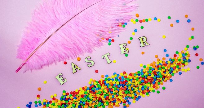 Abstract easter card with scattered color confectionery balls and letters. Easter holiday concept