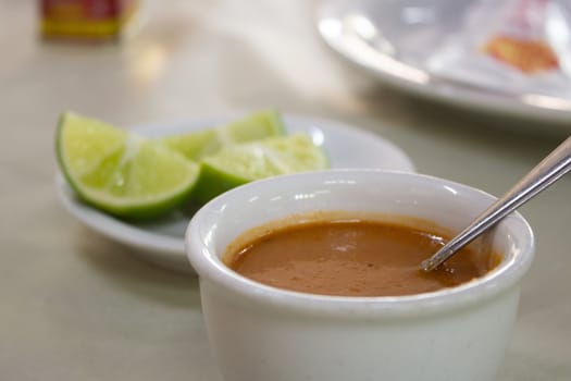 Pepper sauce and lemons, served to go with fish on a restaurant