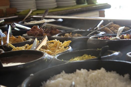 Free buffet at a self service restaurant, serve on a wood burning stove, with rice, fish, fries and farofa