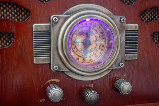 An old fashion radio, featuring a gauge showing the current frequency and knobs to control the system