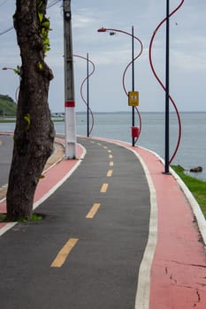 A bicycle road with pedestrian lanes, around the Maricá's Lake. Sign says "shared path, pedestrians have priority".