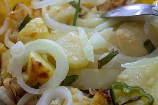 A bowl of cod fish cooked with potatoes, onions and seasonings