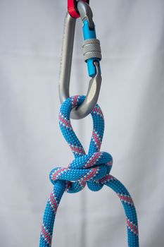 Alpine butterfly knot tied with a climbing rope to a pear shaped locking carabiner