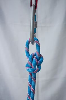 Bowline knot tied with a climbing rope to a pear shaped locking carabiner