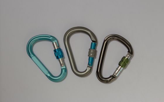 Tree pear shaped screw gate carabiners used in rock climbing