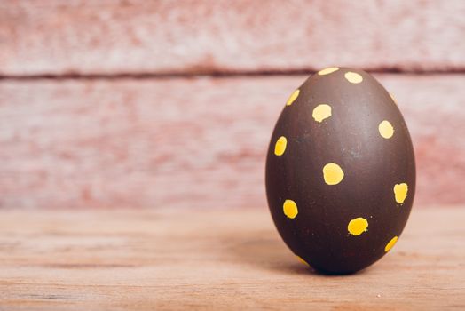 Beautiful Easter Brown egg on wooden background, Easter day concept