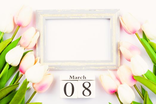 Happy Women's Day, Mother's Day and Valentine's Day concept. top view flat lay Tulip flower and photo frame on white background, copy space for your text