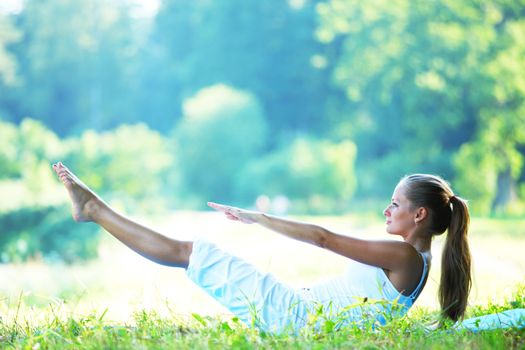 woman lay and training on ground yoga outdoors