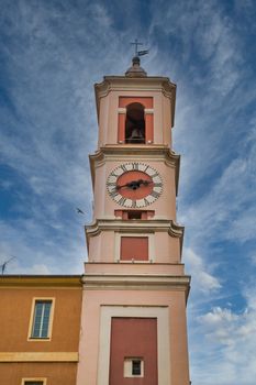 A pink plaster clock tower in Nice, France