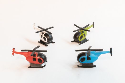 Small colorful helicopter toys isolated on a white background - air travel by helicopter concept.