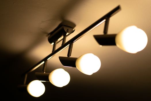 Some warm light bulbs mounted on a ceiling in a house - Electricity and illumination concept, Bucharest, Romania.