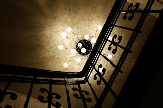 stair case with railing and fancy lamp in Luzern, Switzerland. Reflection on ceiling