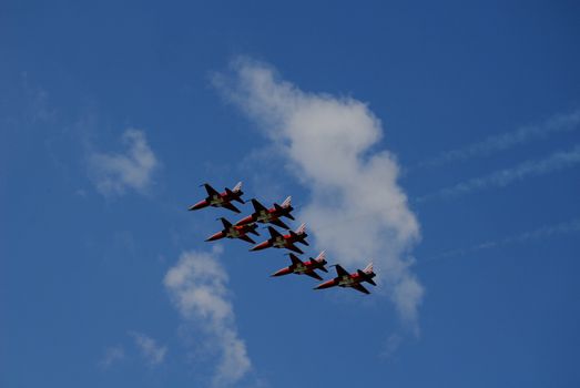Concept of teamwork - patrouille Suisse with blue sky and clouds