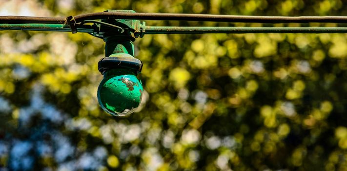 green painted light out in country side with trees in the background