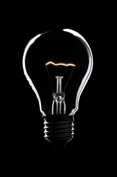 light bulb burning in the night with back background and copy space