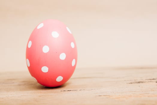 Beautiful Easter Pink egg on wooden background, Easter day concept