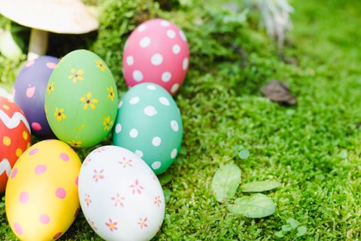Beautiful Easter multi color egg on garden green grass, Easter day concept