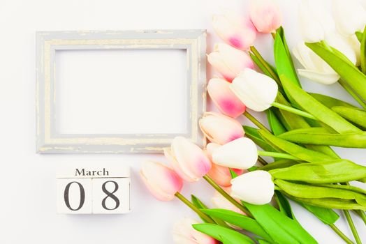 Happy Women's Day, Mother's Day and Valentine's Day concept. top view flat lay Tulip flower and photo frame on white background, copy space for your text