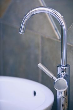 Water tap and sink in domestic bathroom