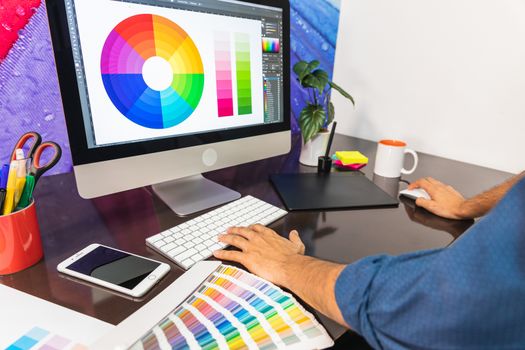 Hands of a young man in front of computer. Graphic Designer work