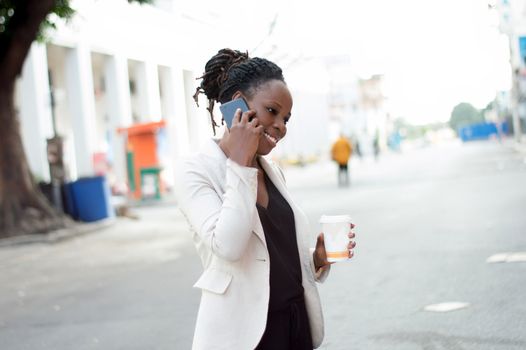 Young business woman smiling in communication holding a box of milk in hand.