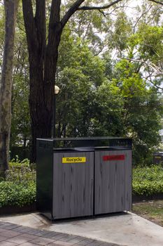 Bin enclosure for recycling waste and landfill in a public park