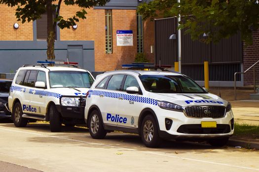 Marked police cars parked outside a local area police station