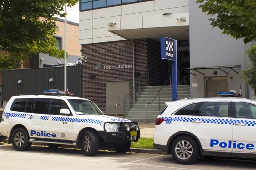 Marked Police vehicles parked outside a local area Police station entrance