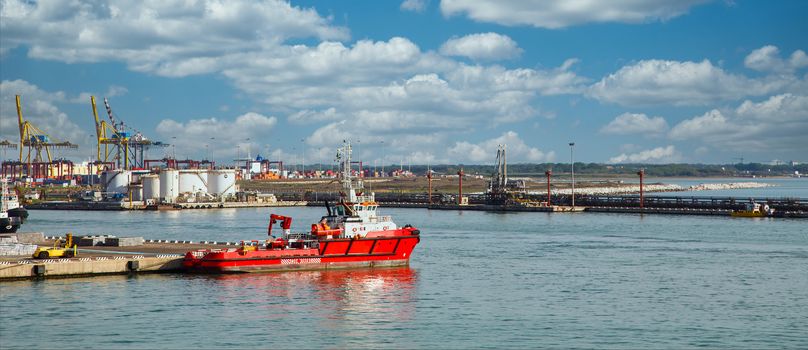 A red rescue boat docked in that harbor of Civitavecchia, Italy