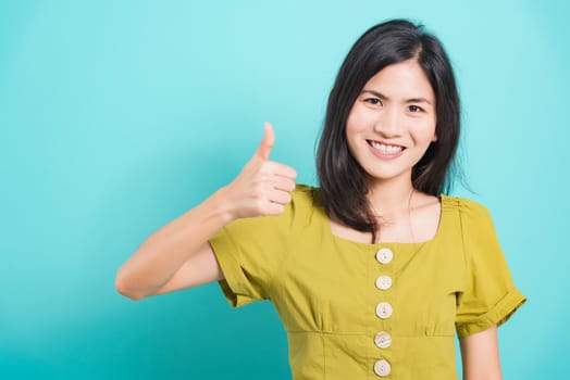 Portrait Asian beautiful young woman standing, She made finger thumbs up, Ok sign to agree and looking at camera, shoot photo in studio on white background, There was copy space