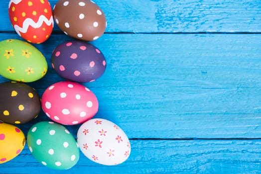 Easter eggs top view on blue wooden background and have copy space for use