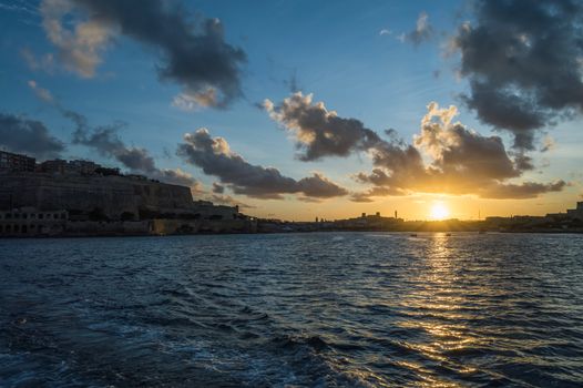 Beautidul sunset over Mediterranean sea and bay of Malta as seen from Valletta.