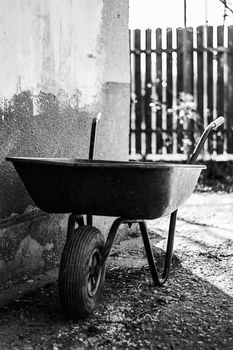 Black and white photo of a wheelbarrow used for carrying in Ialomita, Romania