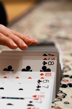 A person doing a ribbon spread with his playing cards