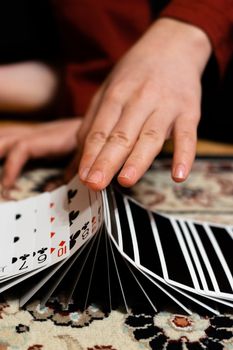A person doing a ribbon spread with his playing cards