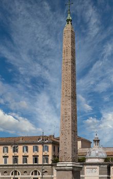 One of the obelisks in Rome rising into blue sky