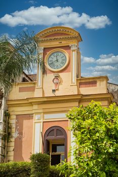 A clock on a nice plaster building in Sorrento on the Amalfi Coast