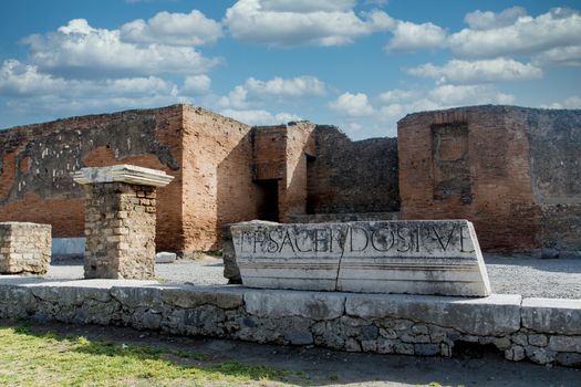 Latin Script on Ancient Stone Wall in Pompeii