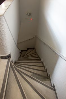 Staircase of a small apartment build with marble steps