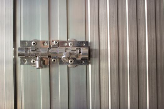 Aluminum latch on an aluminum door frame, brand new and shiny