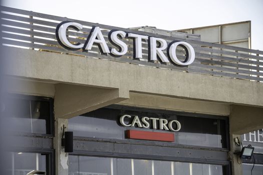 Tel Aviv, Israel - Oct 24, 2019: Castro clothing shop logo sign on the wall of the store entrance building at Tel Aviv Port commercial district. Castro is an Israeli clothing company specializing in men's and women's fashions.