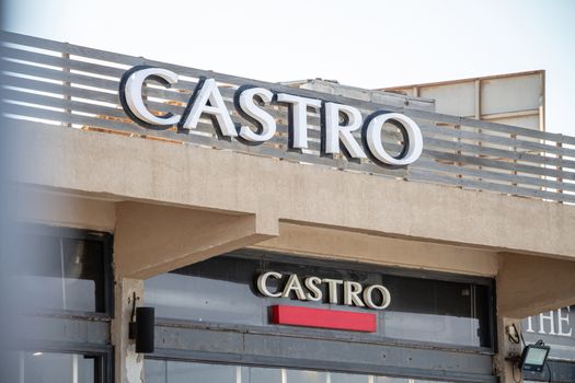 Tel Aviv, Israel - Oct 24, 2019: Castro clothing shop logo sign on the wall of the store entrance building at Tel Aviv Port commercial district. Castro is an Israeli clothing company specializing in men's and women's fashions.