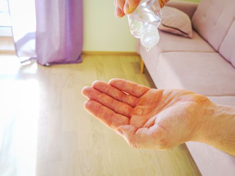 man hands using wash hand sanitizer gel dispenser against Novel coronavirus or Corona Virus Disease Covid-19. Antiseptic, Hygiene and Healthcare concept. Bottle with antibacterial gel in hand.