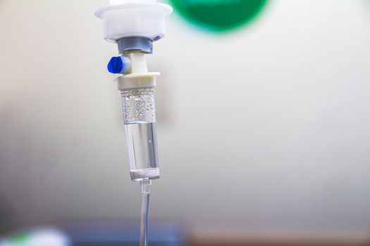 Set IV fluid intravenous drop saline drip in a hospital room. Close up, selective focus and copy space.