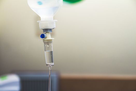 Set IV fluid intravenous drop saline drip in a hospital room. Close up, selective focus and copy space.